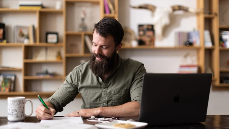 adult student at home doing online school work at BSC